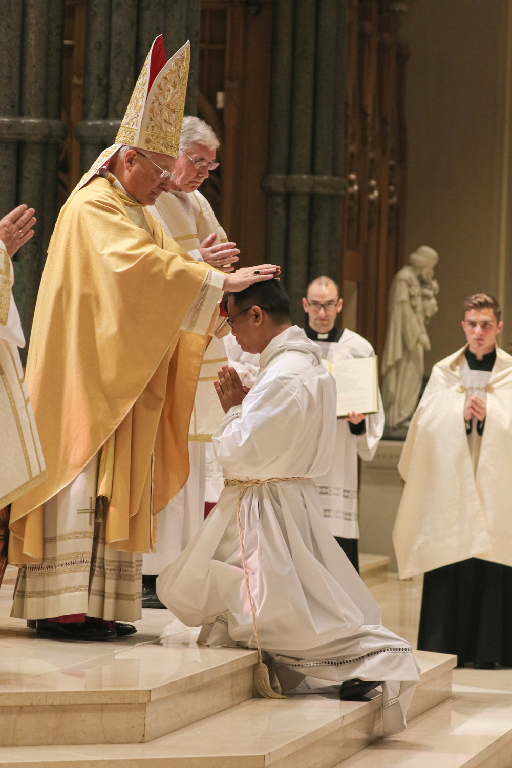 Rev. Mr. Daniel M. Mahoney and Rev. Mr. Doan V. Nguyen are ordained to the Sacred Order of Deacon through the imposition of hands and the invocation of the Holy Spirit, by Auxiliary Bishop Robert C. Evans on Saturday, Sept. 26 at the Cathedral of Saints Peter and Paul, Providence.